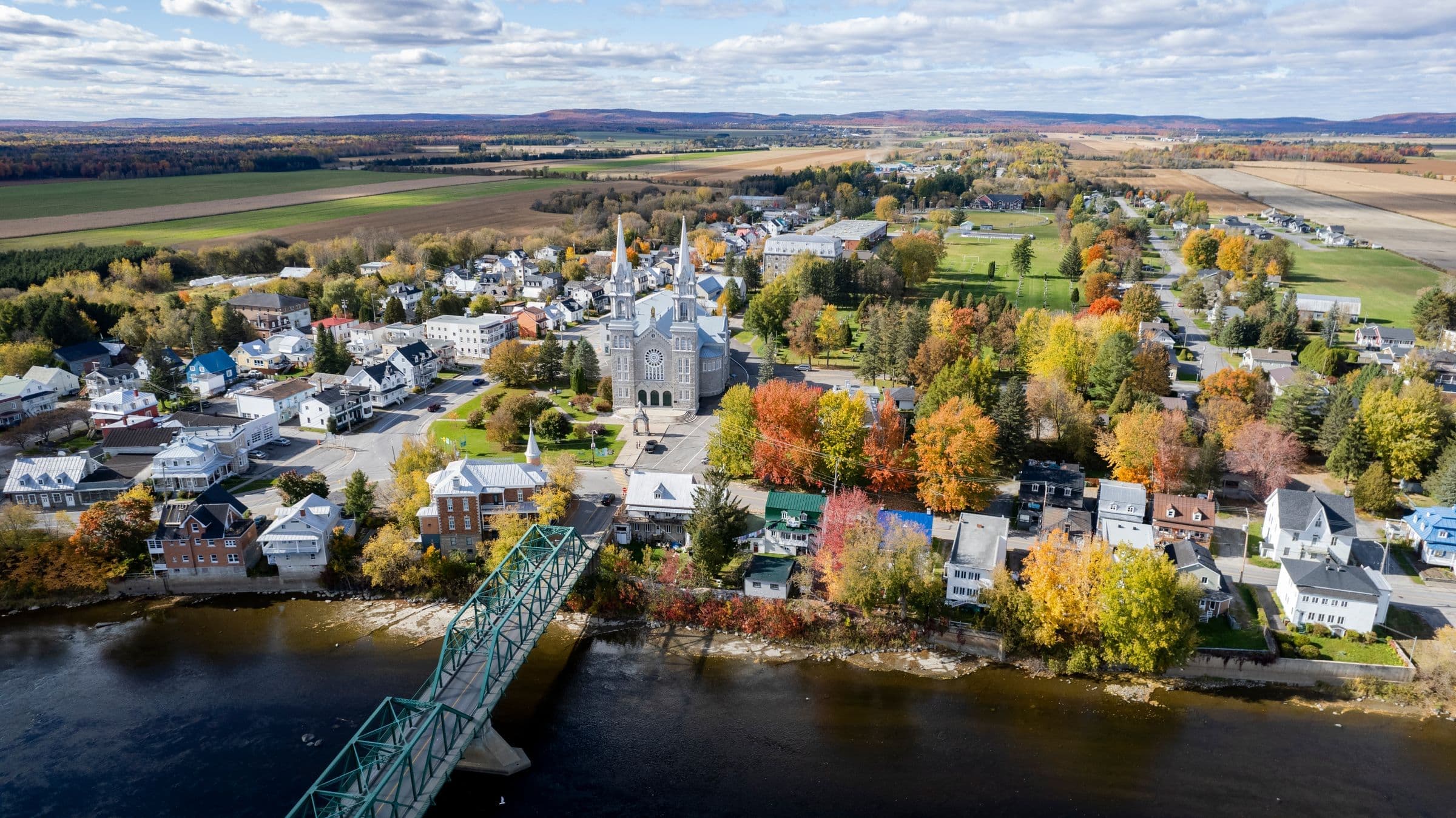A river town with a church seen from above near Hillsborough, NB where we do junk removal