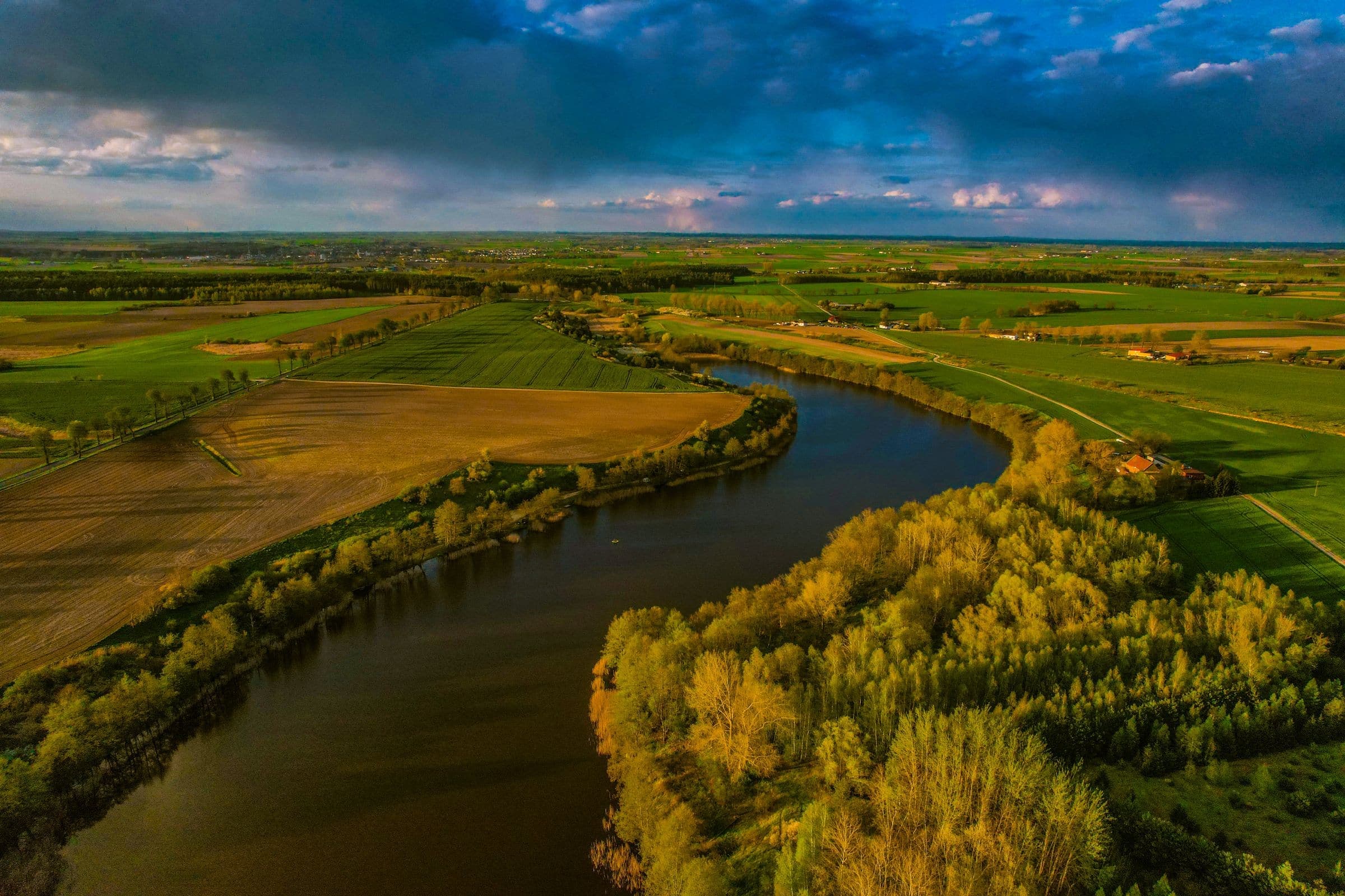 A river winding through farmland near Memramcook, NB where we do junk removal